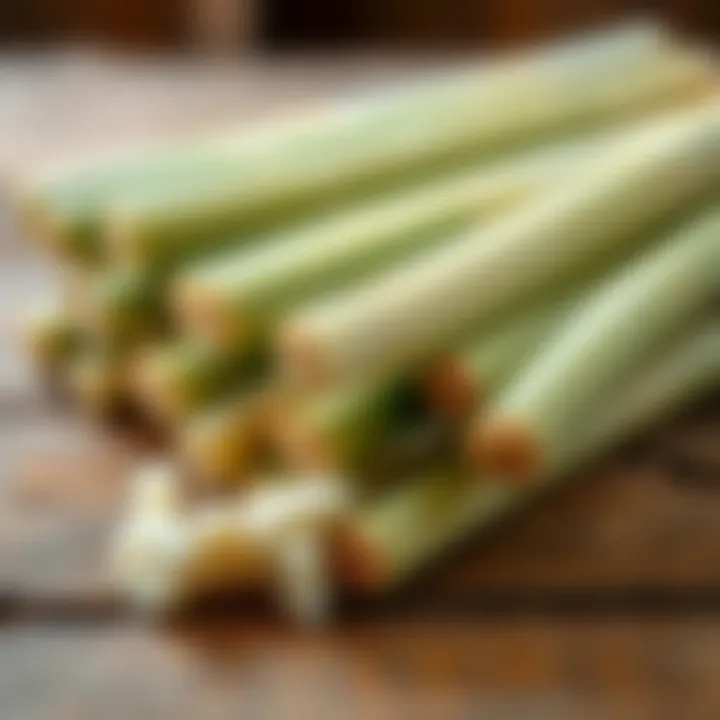Freshly cut sugarcane stalks arranged on a wooden surface